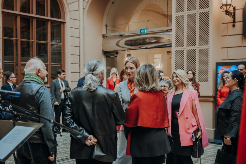 People converse during the exhibition opening event at the Art Museum RĪGAS BIRŽA.