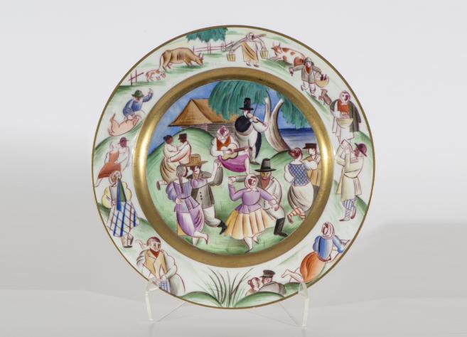 Decorative porcelain plate with a rural dance and musicians scene, with farmers, animals and landscape around the border.