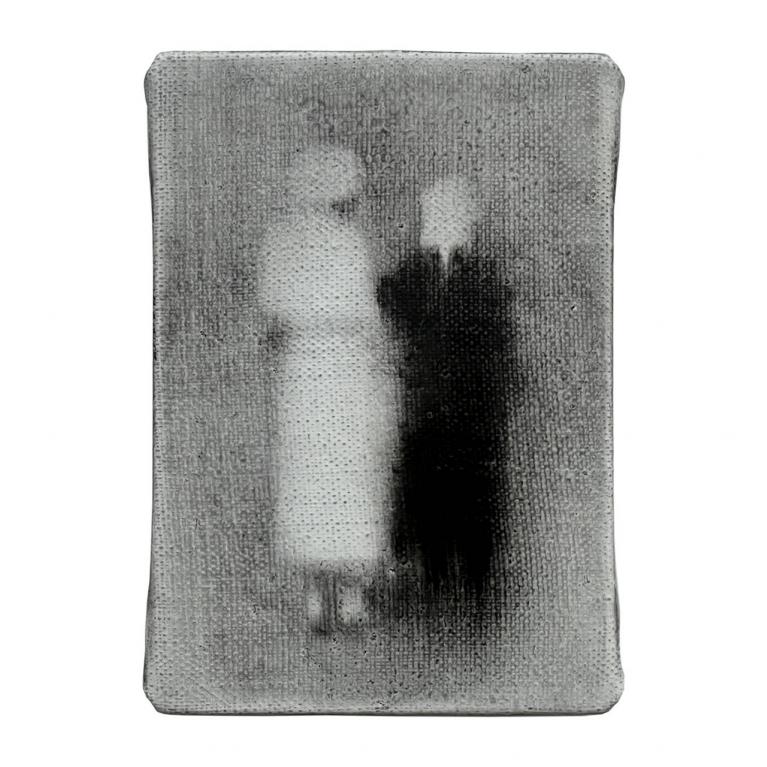 In a small grey-toned image, two blurred human figures stand side by side, one lighter and one darker, creating a vague, ghostlike effect.