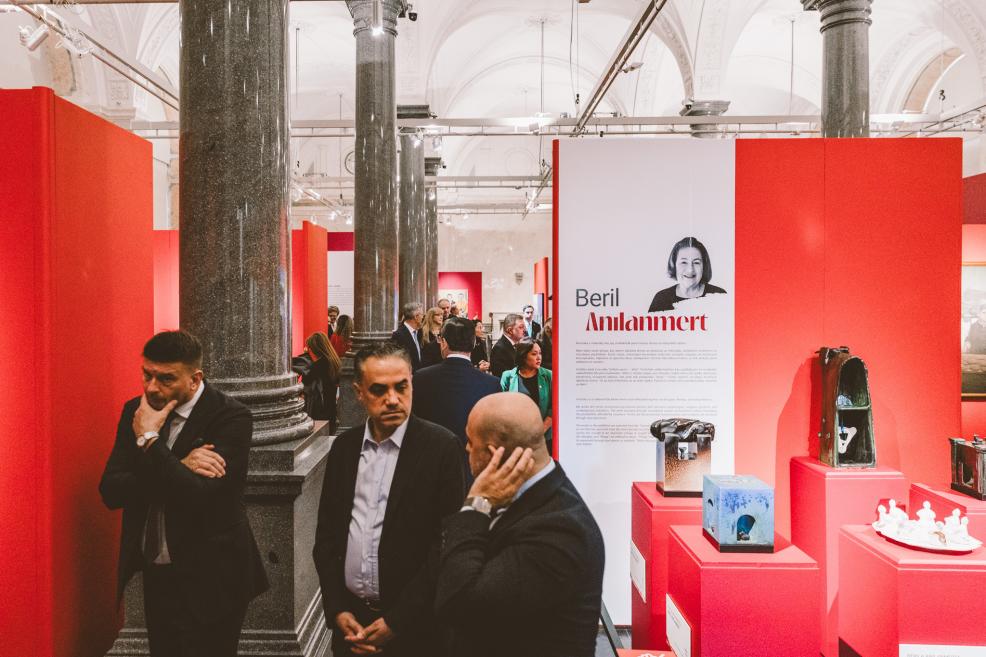 Visitors observe artworks in the exhibition hall.