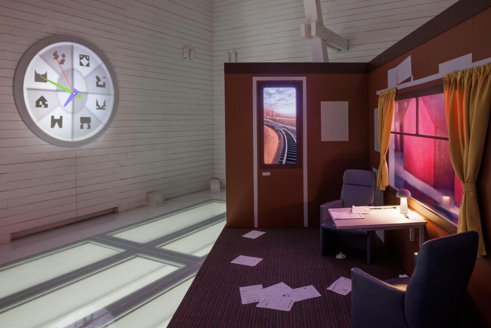 A prop made of a train compartment with moving parts on display