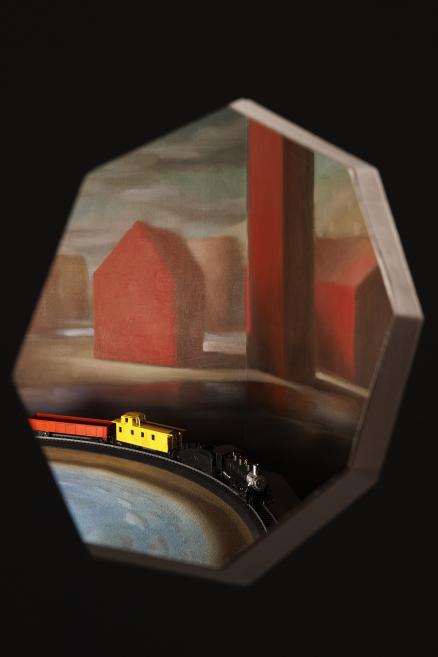 Installation view of a moving train in a painted environment
