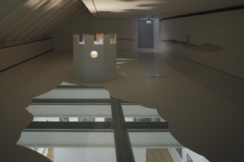 An installation at the exhibition, which is a moving train in a painted landscape