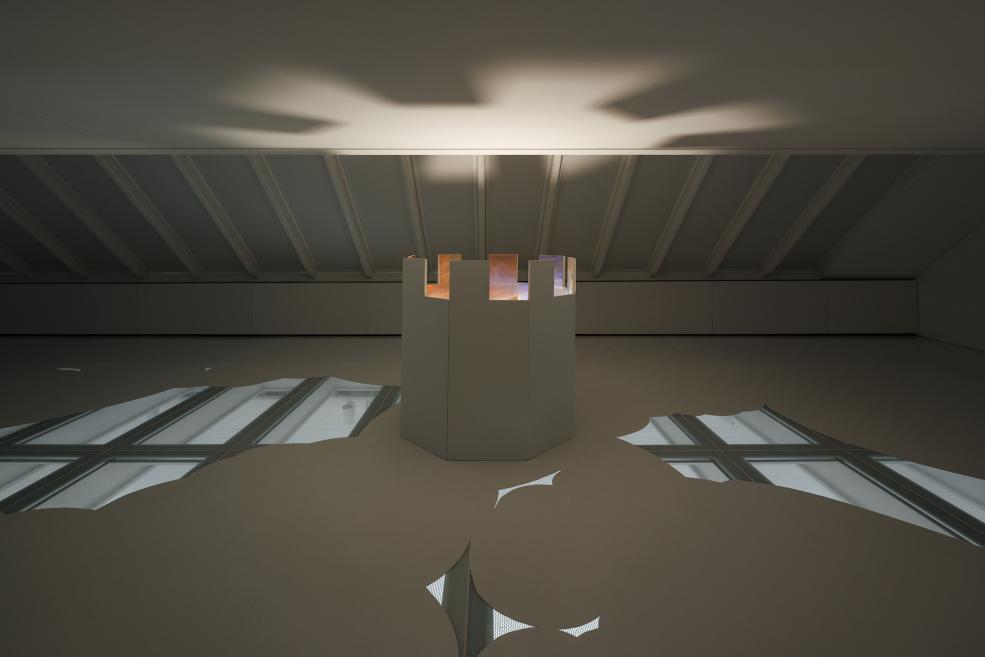 An installation at the exhibition, which is a moving train in a painted landscape