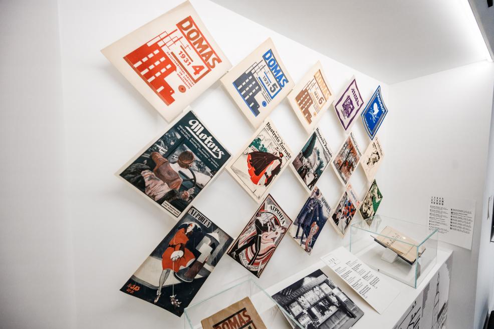 Exhibition display of early 20th-century magazines and posters.