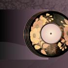 Decorative vinyl record with floral patterns on a dark surface, placed against a stylized purple background with plant shadows.