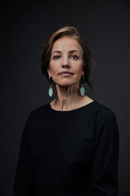 A woman with turquoise earrings.