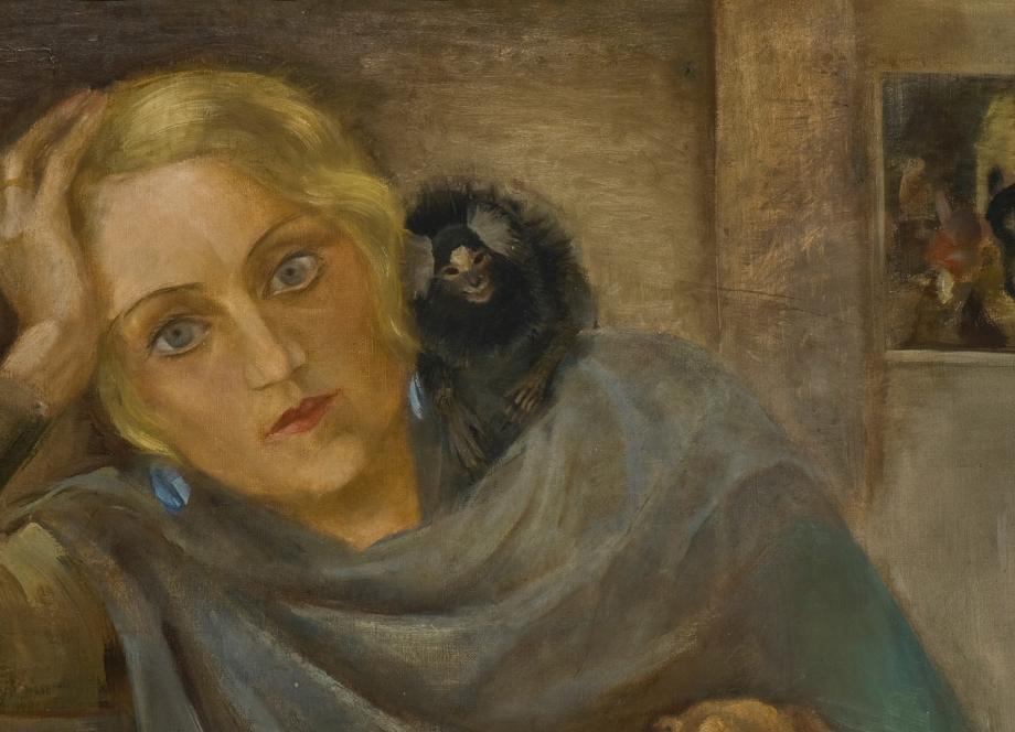 A portrait of a blonde woman resting her head on her hand with a small monkey on her shoulder, with a small painting visible in the background.