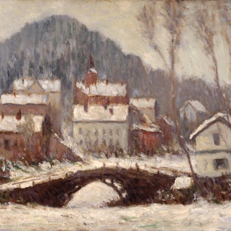 A winter townscape with a bridge over a river and snow-covered houses at the foot of a hill.
