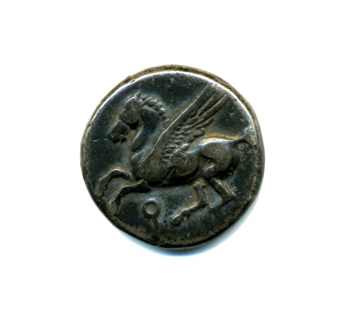 Dark oval metal coin or seal with a relief depiction of a winged horse on a white background.