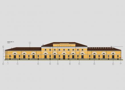 Architectural illustration of a building façade with yellow plaster, white window frames, and a brown roof, featuring the inscription “ARSENĀLS”.