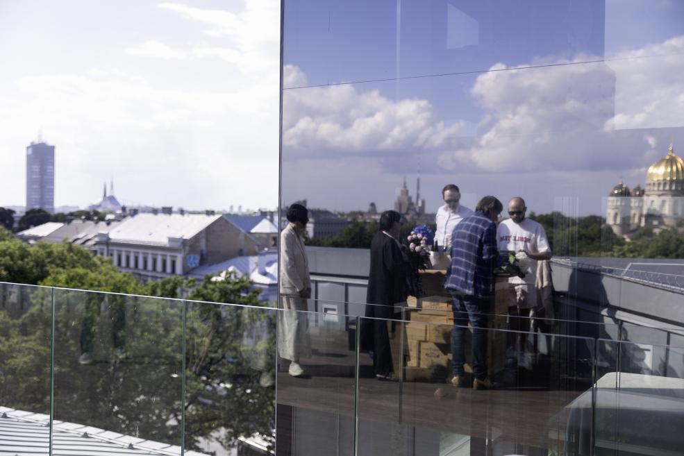 Visitors at the opening of the exhibition on the terrace.