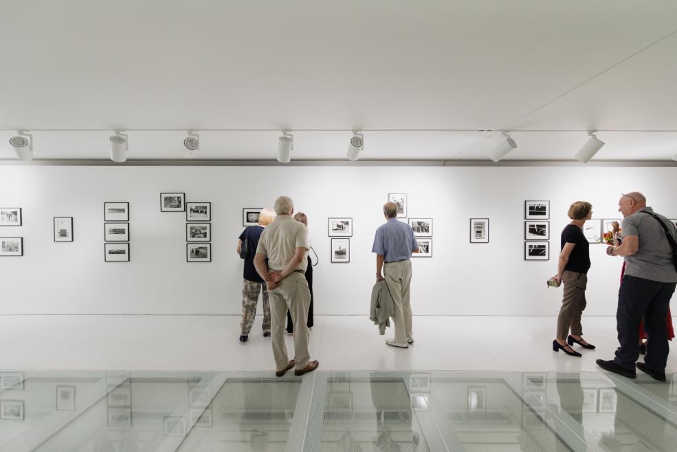 Visitors view the works at the opening of the exhibition.