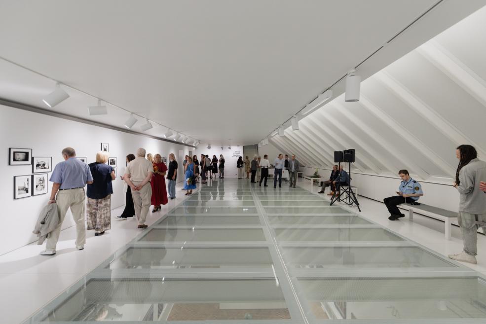 Visitors view the works at the opening of the exhibition.