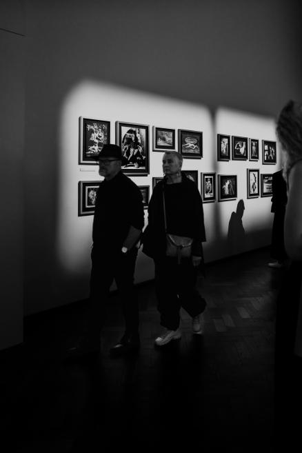 Black and white image with visitors at the opening of the exhibition.