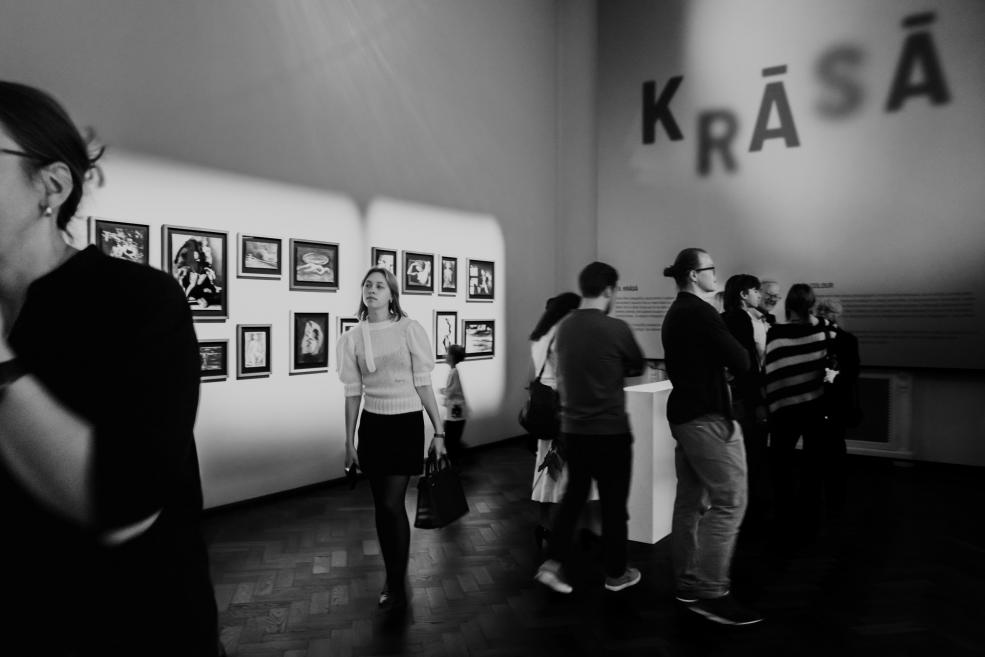 Black and white image with visitors at the opening of the exhibition.