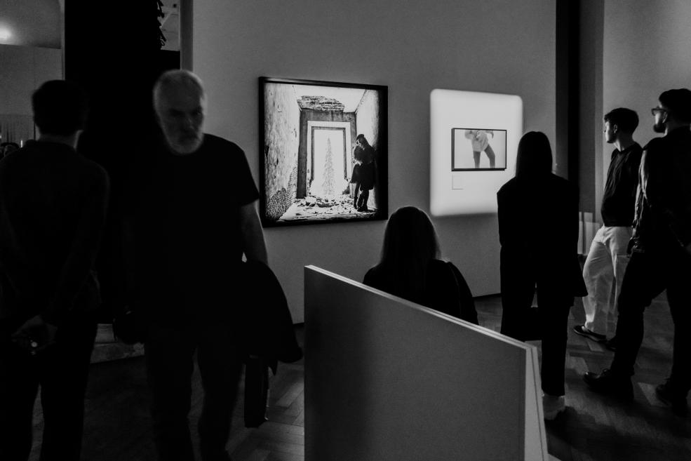 Black and white image with visitors at the opening of the exhibition.