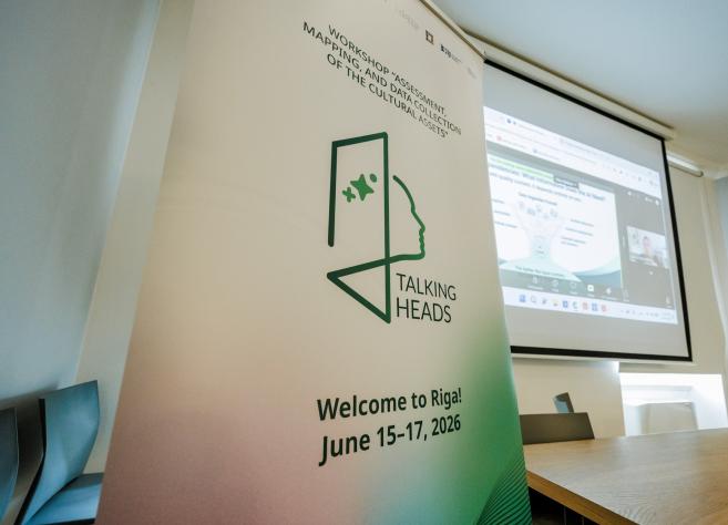 Vertical event banner with the text Workshop Assessment Mapping and Data Collection of the Cultural Assets and Talking Heads, in a conference room beside a projection screen showing a presentation.