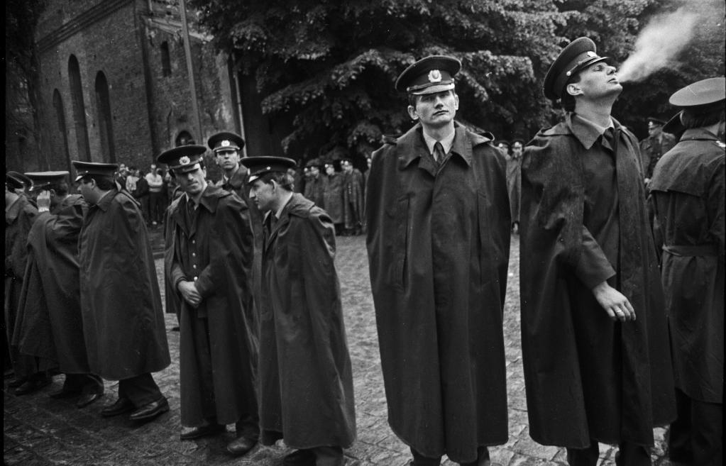 Black and white image of police officers in coats.