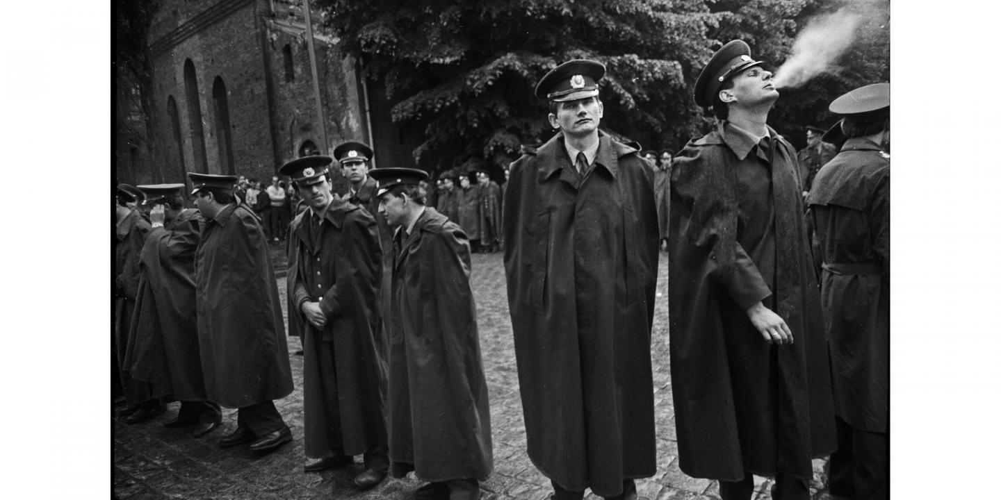 Black and white image of police officers in coats.