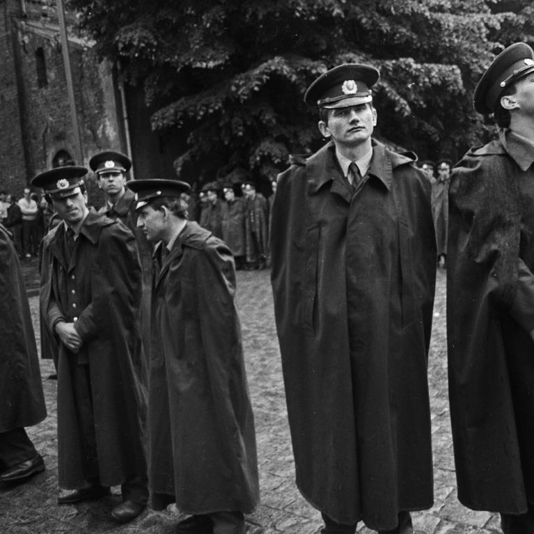 Black and white image of police officers in coats.