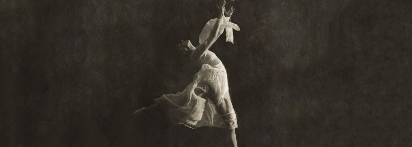 Black and white photo of a ballerina dancing.