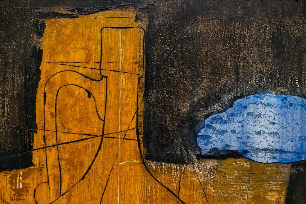An abstract painting with an ochre-yellow vertical form on the left and a blue area on the right, set against a dark, textured background with incised lines.