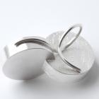 Two interconnected silver-toned metal rings on a white background.
