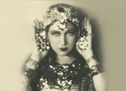 Black and white image of a woman in a theatrical costume.