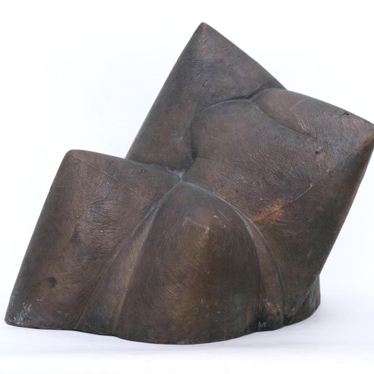 Dark bronze abstract sculpture with geometric folded planes on a white background.