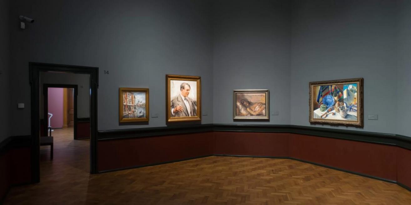 Hall of the Latvian National Museum of Art featuring 20th-century portraits and still-life compositions.