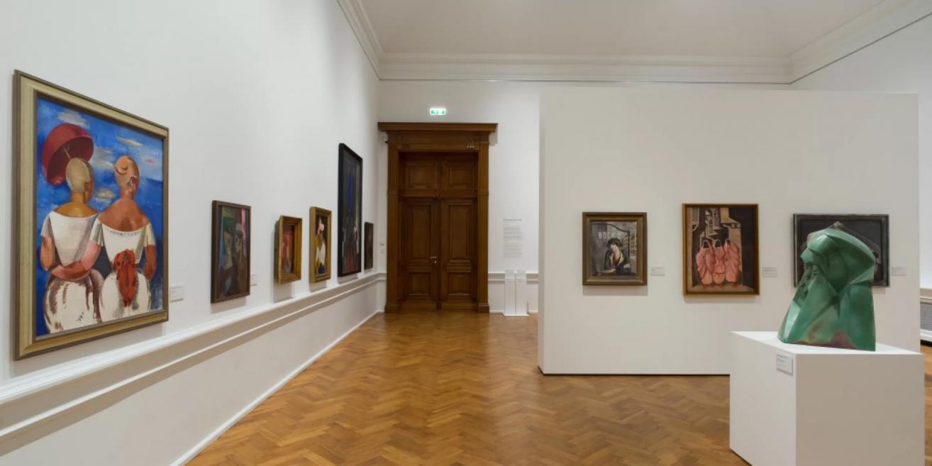 Exhibition hall of the Latvian National Museum of Art displaying 20th-century Latvian painting and sculpture.