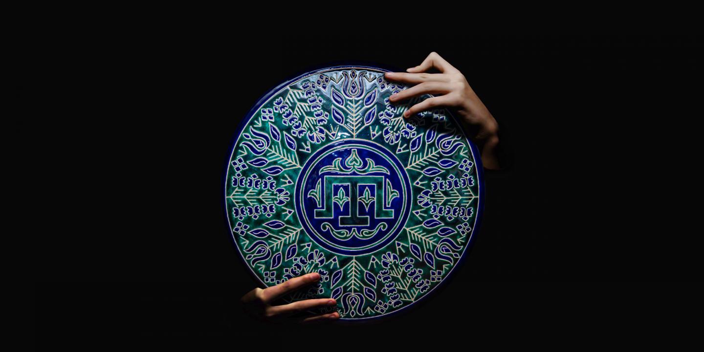 holding an ornamental plate.