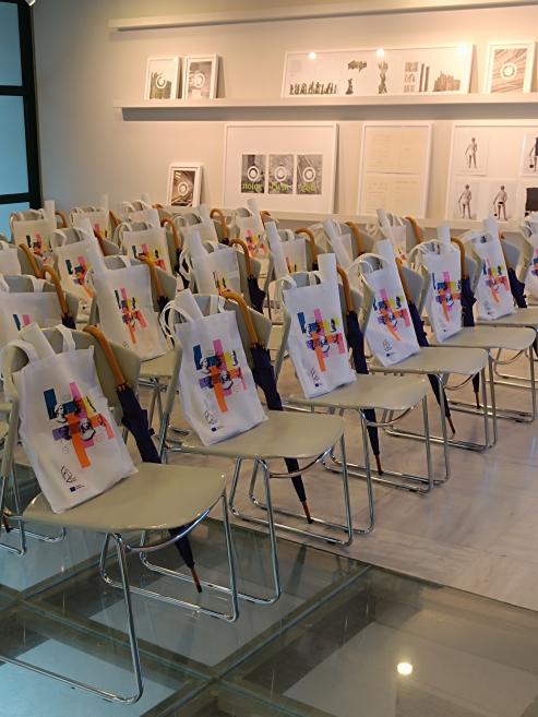 “Talking Heads” workshop room prepared with materials and tote bags for participants before the event.