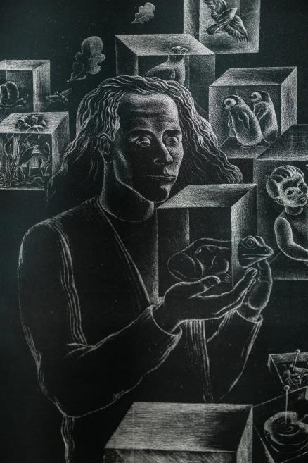 A black-and-white surreal composition featuring a human figure holding frogs, surrounded by spatial cubes containing animal and human figures.