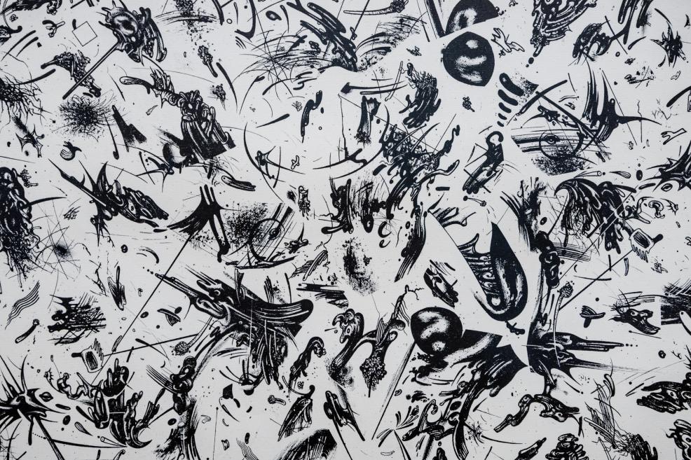 An artwork displayed on a white gallery wall with an informational label beside it.