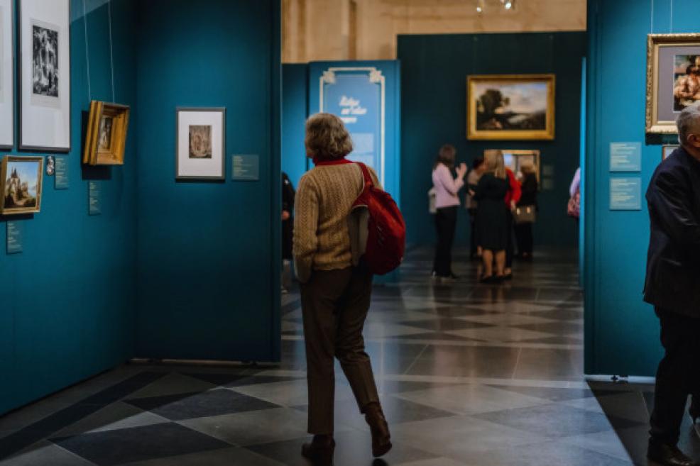 A visitor looks at the works of art in the exhibition.