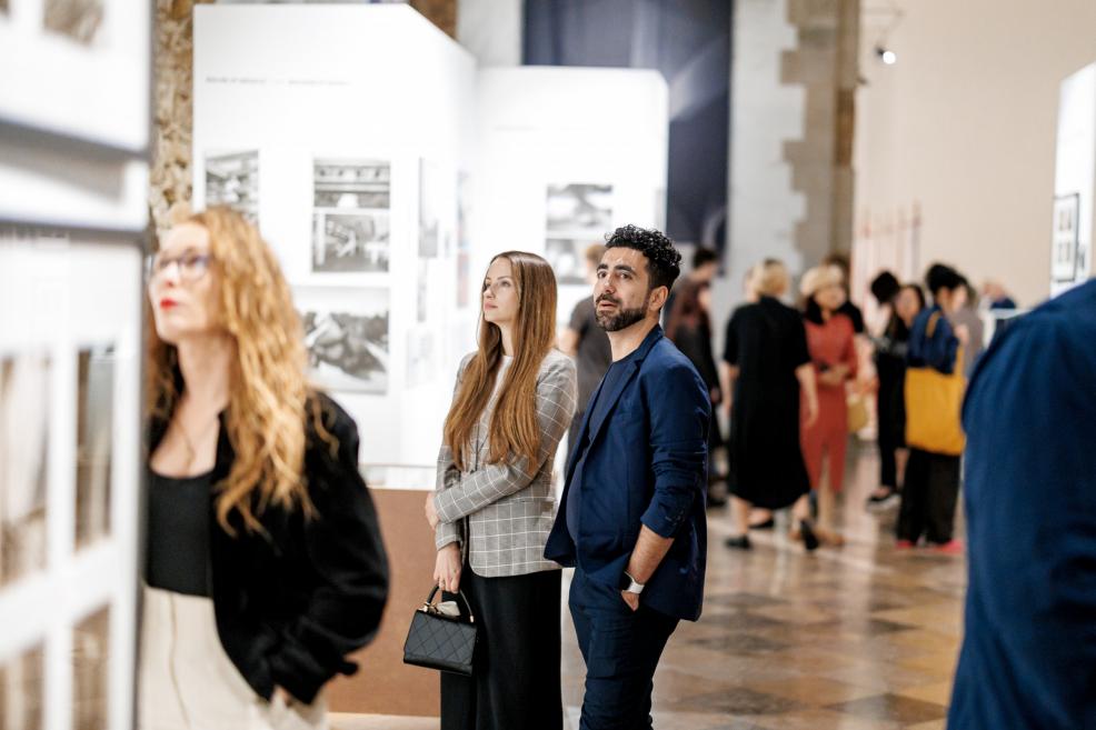 Museum visitors carefully observe the exhibition works.