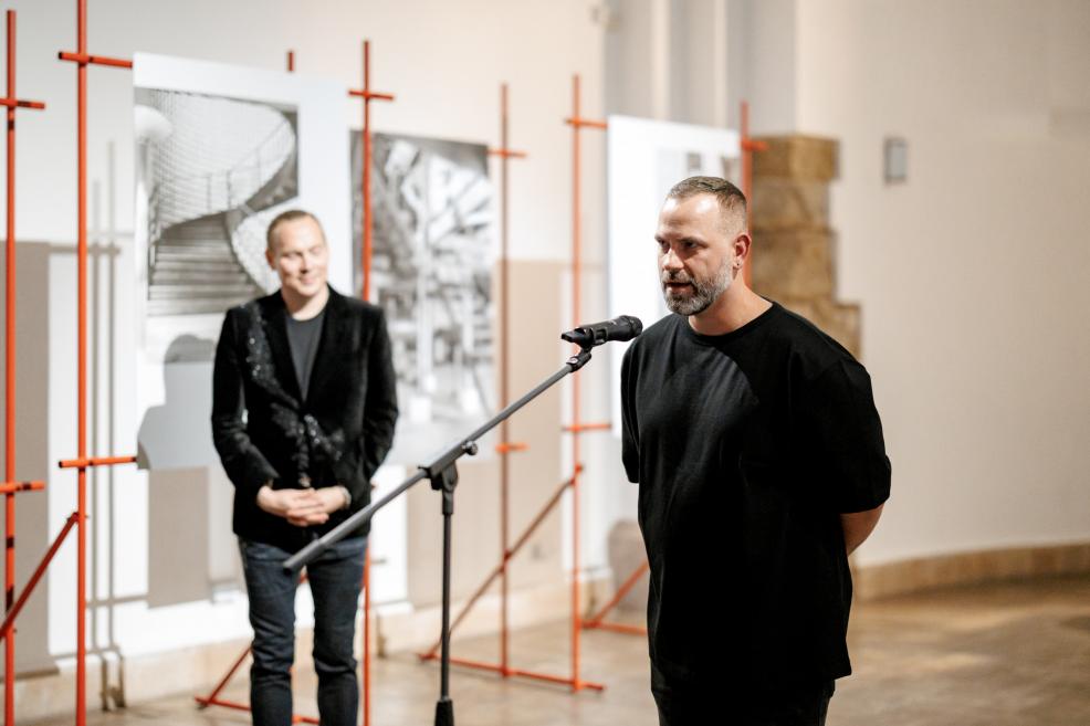 Man delivering a speech at the exhibition opening.
