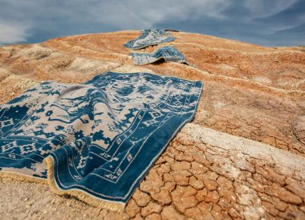 Blue carpets in desert sand.