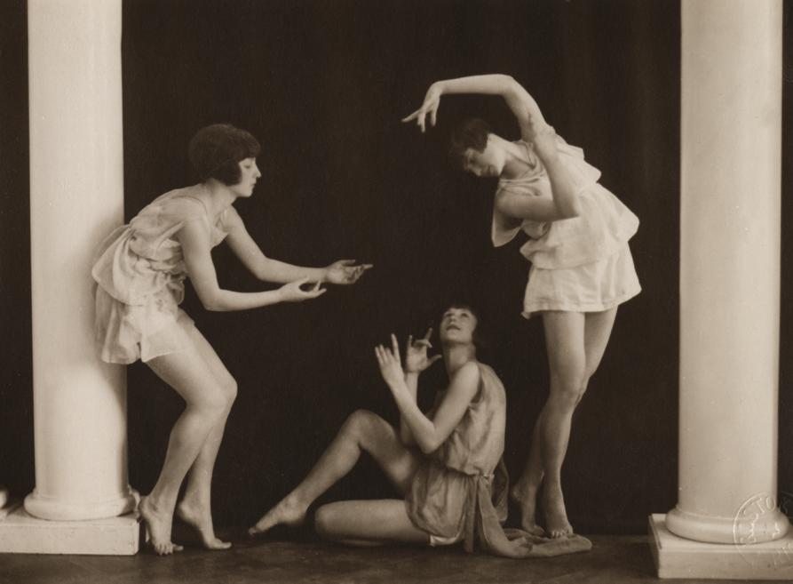 Black and white photo of three ballerinas in different positions.