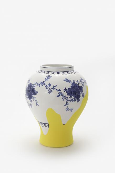 A vase with a floral pattern in blue and yellow tones.