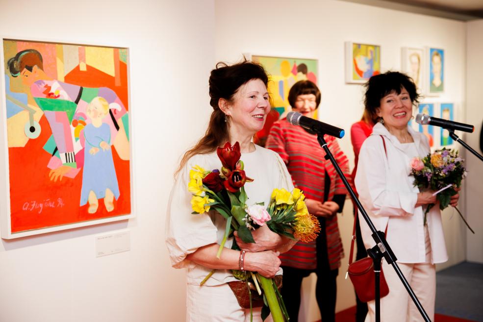 A woman speaks into a microphone.